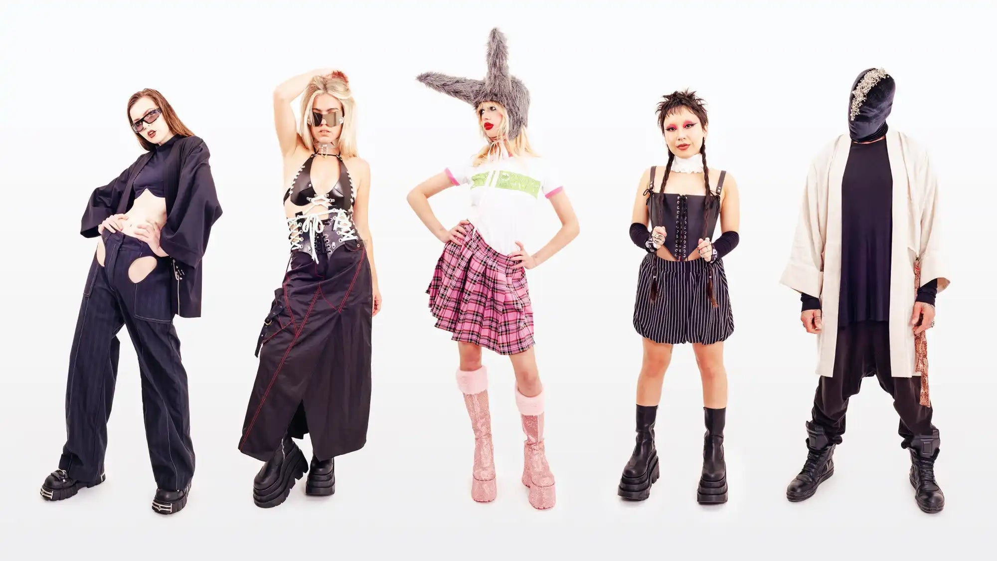 Five people wearing different alternative fashion styles and poses against a white backdrop.